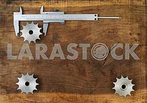 Different construction tools on a wooden background - screwdriver, caliper.