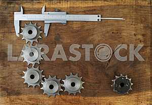 Different construction tools on a wooden background - screwdriver, caliper.