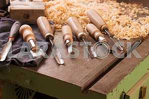 Carpenter tools on wooden table with sawdust. Circular Saw. Carpenter workplace top view