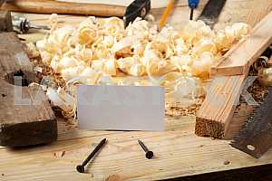 Carpenter tools on wooden table with sawdust. Circular Saw.