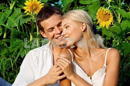 loving couple in a field of sunflowers