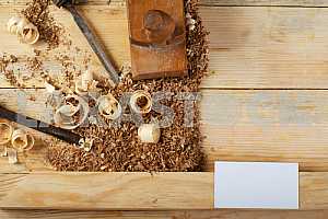 Carpenter tools on wooden table with sawdust. Circular Saw.