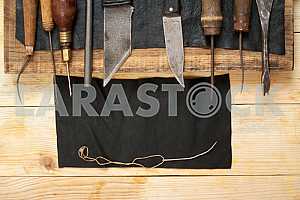 Carpenter tools on wooden table with sawdust. Circular Saw.