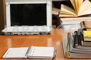 Stack of hardback books on wooden table. Back to school. Copy space. Top view