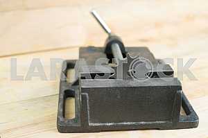 Different construction tools on a wooden background - screwdriver, caliper.