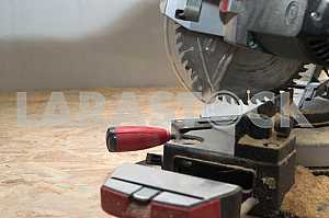 Carpenter tools on wooden table with sawdust. Circular Saw.