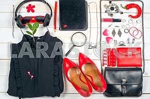 Women clothing set and accessories on white wooden background.