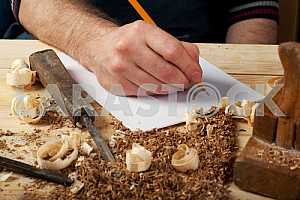 Carpenter tools on wooden table with sawdust. Circular Saw.