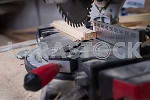 Different construction tools on a wooden background - screwdriver, caliper.