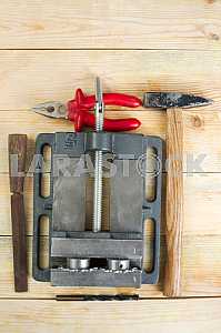 Different construction tools on a wooden background - screwdriver, caliper.