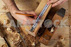 Carpenter tools on wooden table with sawdust. Circular Saw.