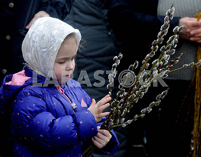 The girl holds the willow twigs