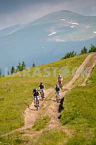 Tourists with backpacks on the bike in the Carpathian Mountains