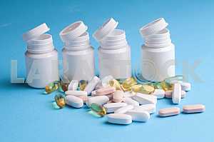Many pills and tablets isolated on light blue background