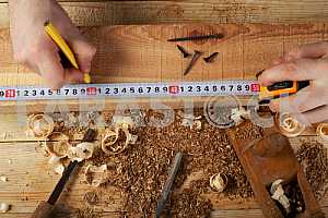 Carpenter tools on wooden table with sawdust. Circular Saw.