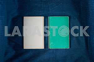 Open book, stack of hardback books on wooden table. Back to school. Copy space
