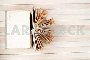 Stack of hardback books on blue cloth. Back to school. Copy space