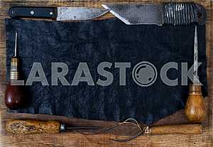 Different construction tools on a wooden background - screwdriver, caliper.
