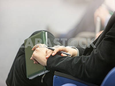 Hands of businessman with notebook