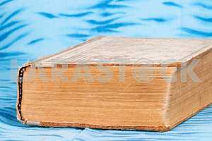 Old and used hardback books or text books on wooden table. Books and reading are essential for self improvement, gaining knowledge and success in our careers, business and personal lives. Copy space