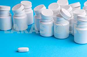 Many pills and tablets isolated on light blue background