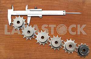 Different construction tools on a wooden background - screwdriver, caliper.