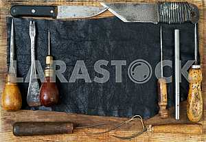 Different construction tools on a wooden background - screwdriver, caliper.