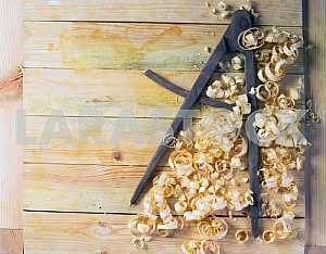 Carpenter tools on wooden table with sawdust. Circular Saw.