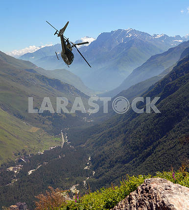 The helicopter flies in mountains