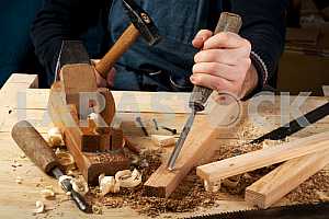 Carpenter tools on wooden table with sawdust. Circular Saw.