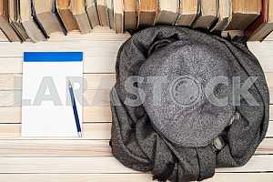 Stack of hardback books on wooden table. Back to school. Copy space. Top view