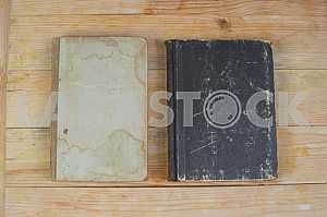 Open book, stack of hardback books on wooden table. Back to school. Copy space
