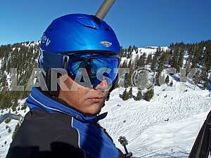 A skier in helmet and goggles. The ski slopes of the