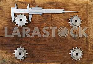 Different construction tools on a wooden background - screwdriver, caliper.