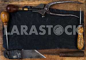 Different construction tools on a wooden background - screwdriver, caliper.