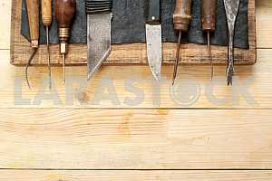 Carpenter tools on wooden table with sawdust. Circular Saw.