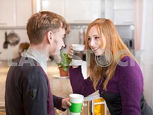 Young happy couple drinking tea in the morning