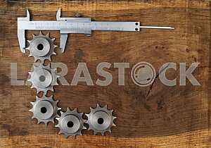 Different construction tools on a wooden background - screwdriver, caliper.