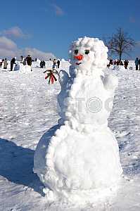 Big snowman on sky background
