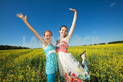 Two girlfriends having fun in blue sky