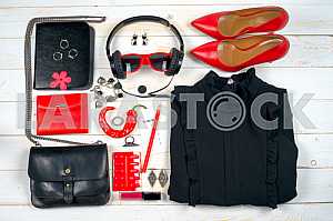 Women clothing set and accessories on white wooden background.