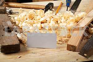 Carpenter tools on wooden table with sawdust. Circular Saw.