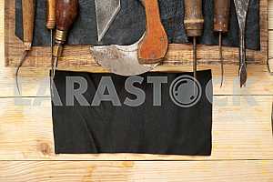Carpenter tools on wooden table with sawdust. Circular Saw.