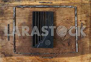Different construction tools on a wooden background - screwdriver, caliper.
