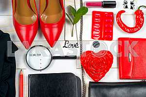 Women clothing set and accessories on white wooden background.