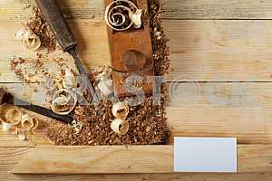 Carpenter tools on wooden table with sawdust. Circular Saw.