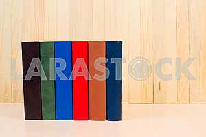 Открытая книга, стопка книг в твердом переплете на деревянном столе. Обратно в школу. Копирование пространства