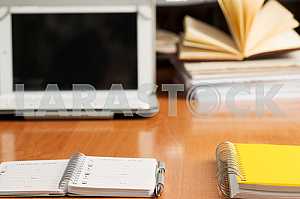 Stack of hardback books on wooden table. Back to school. Copy space. Top view