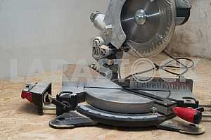 Carpenter tools on wooden table with sawdust. Circular Saw.