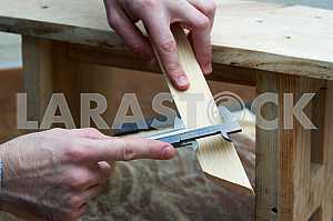 Different construction tools on a wooden background - screwdriver, caliper.